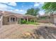 Backyard with covered patio, low-maintenance desert landscaping, and privacy shrubs at 2701 Glencliff Dr, Las Vegas, NV 89134