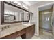 Well-lit bathroom with a large mirror, granite countertop, and a glass-enclosed shower, offering a spa-like feel at 2701 Glencliff Dr, Las Vegas, NV 89134