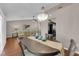 Open dining room with a wooden table, chandelier, and hardwood floors next to a comfortable living area at 2701 Glencliff Dr, Las Vegas, NV 89134