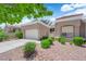 Well-kept home showcasing desert landscaping, a two-car garage, and a tile roof under a sunny blue sky at 2701 Glencliff Dr, Las Vegas, NV 89134