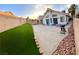 Backyard with a lawn, a concrete patio and surrounding block wall at 2813 Painted Rose Ln, Henderson, NV 89074