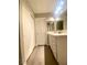 Well-lit bathroom with vanity, mirror, modern flooring and closet at 2813 Painted Rose Ln, Henderson, NV 89074