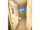 Bathroom with tiled walls and floors, vanity and walk-in shower at 2813 Painted Rose Ln, Henderson, NV 89074