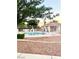Community pool featuring a fenced area for safety and lounging, with ample seating at 2813 Painted Rose Ln, Henderson, NV 89074