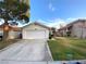 Exterior view of home featuring a two car garage and lawn at 2813 Painted Rose Ln, Henderson, NV 89074