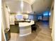 Modern kitchen that opens to a large living room and features stainless steel appliances and granite countertops at 2813 Painted Rose Ln, Henderson, NV 89074