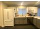 Bright kitchen featuring white cabinets, stainless steel appliances, and granite countertops at 2813 Painted Rose Ln, Henderson, NV 89074