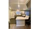 The bright modern kitchen features stainless steel appliances and granite countertops with bar stool seating at 2813 Painted Rose Ln, Henderson, NV 89074