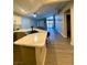 Spacious open layout featuring a modern kitchen with granite countertops and a living room area at 2813 Painted Rose Ln, Henderson, NV 89074