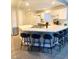 Bright kitchen featuring a quartz countertop island with seating, white cabinets, and stainless steel appliances at 2813 Painted Rose Ln, Henderson, NV 89074