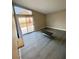 Bright living room with sliding glass door to the backyard and modern flooring at 2813 Painted Rose Ln, Henderson, NV 89074