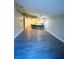 Spacious living room with open floor plan into kitchen with bar top and sleek modern flooring at 2813 Painted Rose Ln, Henderson, NV 89074