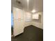 Bright pantry area featuring a large pantry closet, white cabinets, and dark floors at 2813 Painted Rose Ln, Henderson, NV 89074