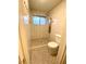Updated shower with rain shower head, body jets, tiled walls, and a modern toilet at 2813 Painted Rose Ln, Henderson, NV 89074