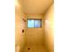 Walk-in shower with window, tiled walls, and updated shower head at 2813 Painted Rose Ln, Henderson, NV 89074