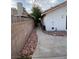 Side yard featuring a concrete path, rock landscaping and privacy wall at 2813 Painted Rose Ln, Henderson, NV 89074