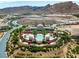 High aerial showcases the community, pool, clubhouse, lush landscaping, and golf course at 30 Via Vasari # 103, Henderson, NV 89011