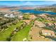 Golf course community near a lake with tiled rooftops and mountain views at 30 Via Vasari # 103, Henderson, NV 89011