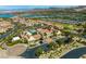 Aerial view of the community with a pool, clubhouse, and golf course with lake view at 30 Via Vasari # 103, Henderson, NV 89011