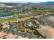 Aerial view of the community featuring mature landscaping, a pool, clubhouse, and golf course at 30 Via Vasari # 103, Henderson, NV 89011