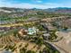 Aerial view showcases the community pool, clubhouse, landscaping, and golf course at 30 Via Vasari # 103, Henderson, NV 89011