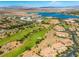 Beautiful aerial view of a golf course community near a lake with mountain views and tiled rooftops at 30 Via Vasari # 103, Henderson, NV 89011
