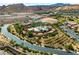 Aerial view features a community pool, clubhouse, lush landscaping, and golf course at 30 Via Vasari # 103, Henderson, NV 89011