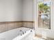 Luxurious soaking tub near the window for a relaxing bath experience at 30 Via Vasari # 103, Henderson, NV 89011