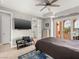Bedroom with balcony, ceiling fan, and integrated entertainment system at 30 Via Vasari # 103, Henderson, NV 89011