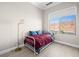 Bright bedroom with large window and a view to the outdoors at 30 Via Vasari # 103, Henderson, NV 89011