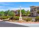 View of the Vasari community entrance with landscaped median and well-maintained villa-style homes at 30 Via Vasari # 103, Henderson, NV 89011