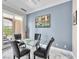 Dining area with contemporary table set, neutral paint and a slider door to the patio at 30 Via Vasari # 103, Henderson, NV 89011