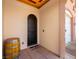 Welcoming front entryway with decorative barrel and neutral color palette at 30 Via Vasari # 103, Henderson, NV 89011