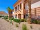 Stunning three story exterior with decorative archways and beautiful landscaping at 30 Via Vasari # 103, Henderson, NV 89011