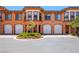 Inviting townhome with multiple garage doors and well-maintained landscaping at 30 Via Vasari # 103, Henderson, NV 89011