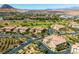 Panoramic view of homes on a golf course, showcasing desert landscaping, multiple units and mountain views in the background at 30 Via Vasari # 103, Henderson, NV 89011