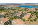 Homes in a golf course community near a lake with tiled rooftops, desert landscaping and mountain views at 30 Via Vasari # 103, Henderson, NV 89011