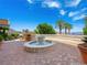 A serene community fountain with lush landscaping and stunning lake views at 30 Via Vasari # 103, Henderson, NV 89011