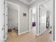 Hallway featuring wood flooring, multiple doorways, and access to a bathroom and bedroom at 30 Via Vasari # 103, Henderson, NV 89011