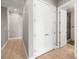 Hallway with wood flooring leading to bedrooms, bathrooms, and closet space at 30 Via Vasari # 103, Henderson, NV 89011