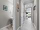 Well-lit hallway features a convenient powder room and flows into a spacious living area with stylish marble floors at 30 Via Vasari # 103, Henderson, NV 89011