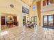 Open-concept living room with travertine floors and natural light at 30 Via Vasari # 103, Henderson, NV 89011