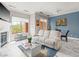 Comfortable living area with a fireplace, a cozy couch, and large windows offering plenty of natural light at 30 Via Vasari # 103, Henderson, NV 89011