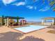 Community pool featuring lounge areas with shaded pergola and desert views at 30 Via Vasari # 103, Henderson, NV 89011