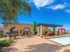 Resort-style pool area featuring a built-in BBQ area, covered seating, and desert views at 30 Via Vasari # 103, Henderson, NV 89011