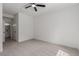 A sunlit bedroom with neutral carpet and white walls leading to the bathroom at 3318 N Decatur Blvd # 1020, Las Vegas, NV 89130