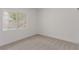 Bright bedroom with neutral carpet and a window offering natural light and neighborhood views at 3318 N Decatur Blvd # 1020, Las Vegas, NV 89130
