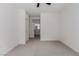 A cozy bedroom with neutral carpet and an open doorway to the bathroom at 3318 N Decatur Blvd # 1020, Las Vegas, NV 89130