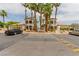 Beautiful community clubhouse featuring well-manicured landscaping and multiple tall palm trees at 3318 N Decatur Blvd # 1020, Las Vegas, NV 89130