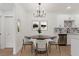 Dining area with a table, stylish chandelier, and adjacent kitchen for convenient meals at 3318 N Decatur Blvd # 1020, Las Vegas, NV 89130